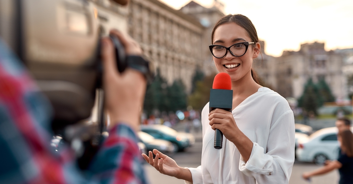 TV reporter presenting the news outdoors