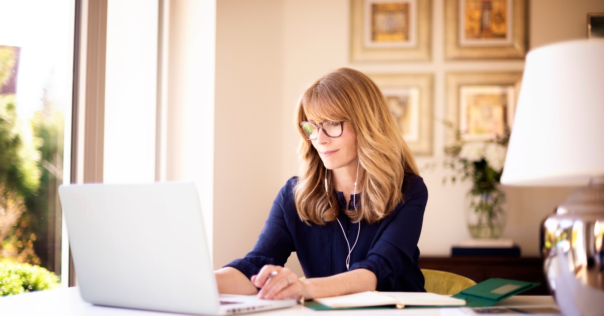 woman sitting behind her laptop and working from home