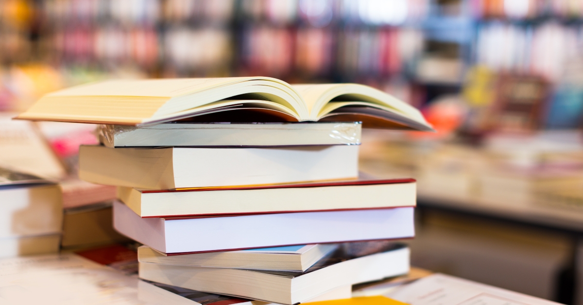 stack of books lying on table in bookstore