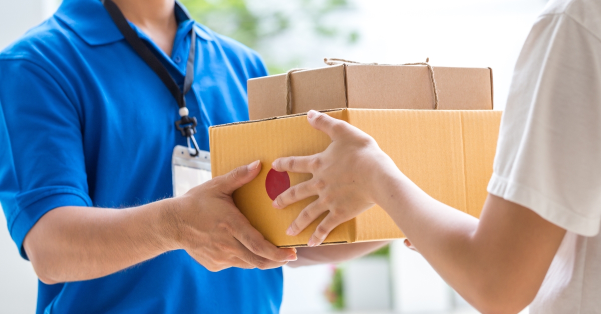 woman hand accepting a delivery of boxes from deliveryman