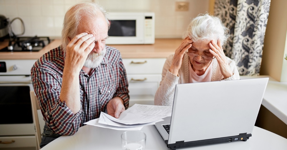 worried couple looking at documents 