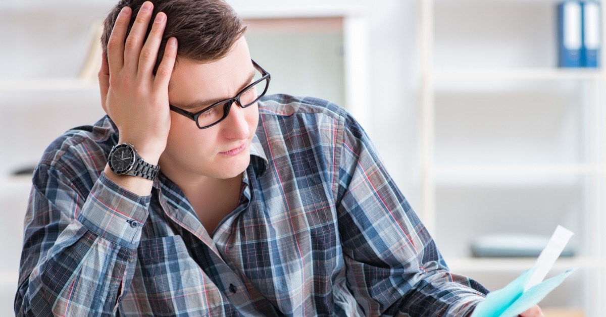 young man reviewing documents on table