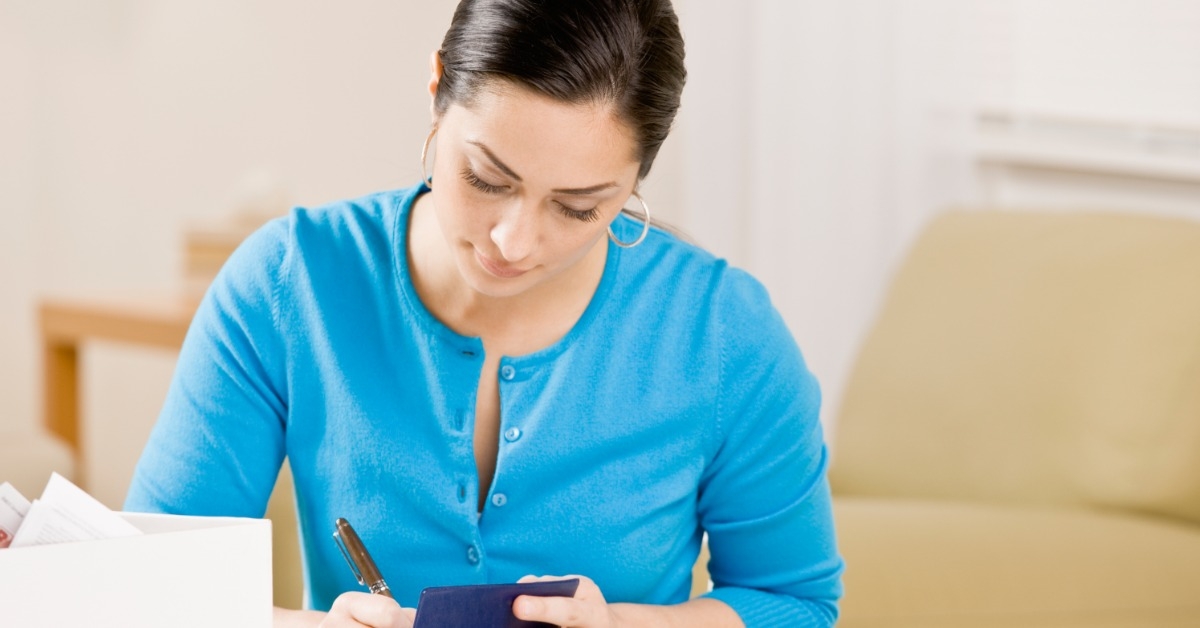 woman writing on notebook