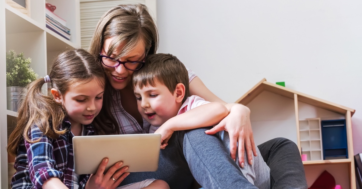 mom with two kids using tablet 