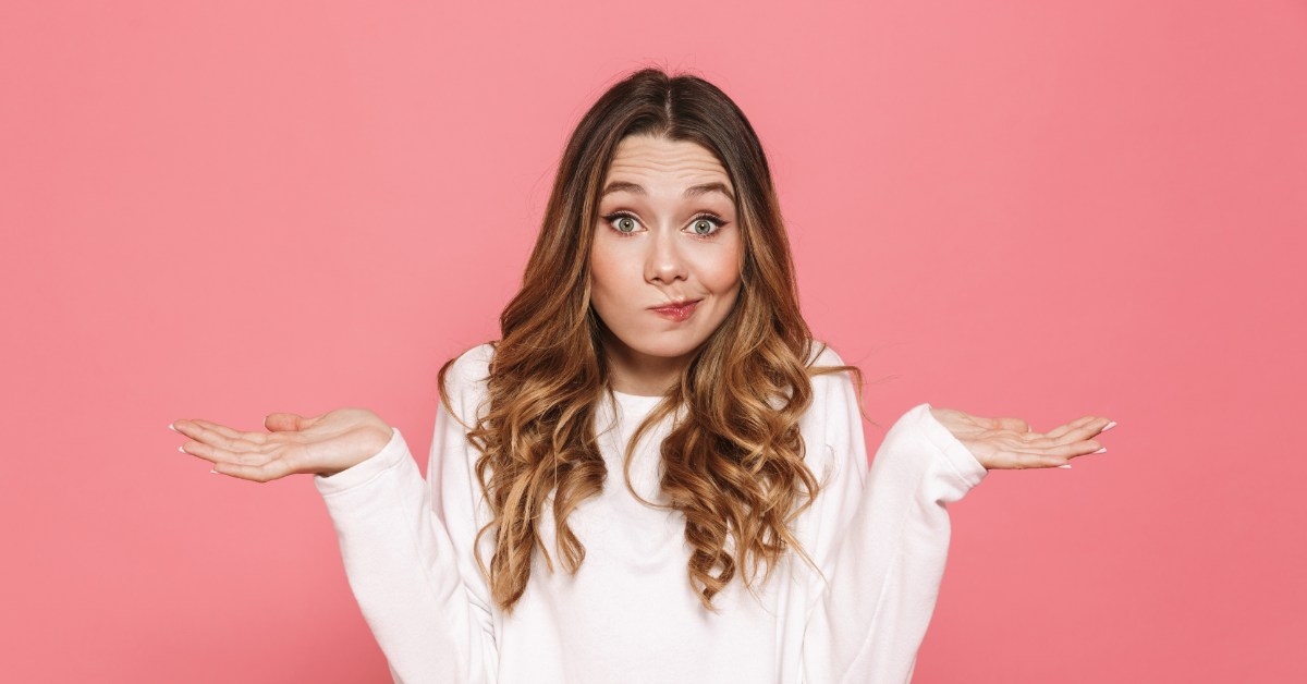 beautiful young women shrugging hands in confusion