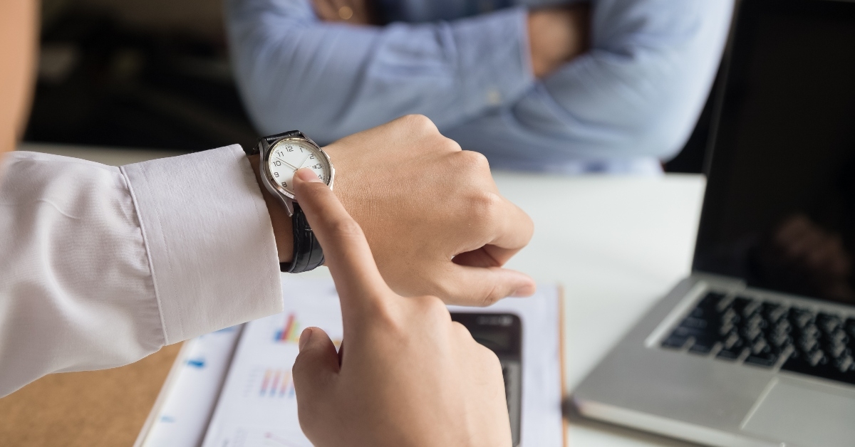 businessman angry and pointing at his smart watch