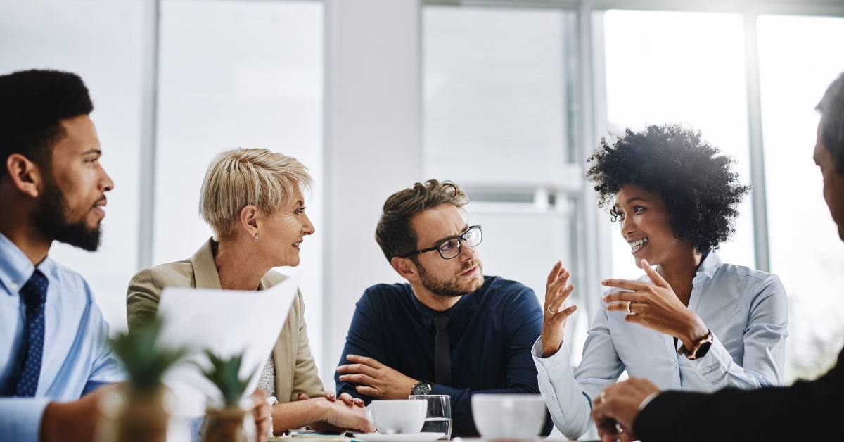 group of businesspeople sitting together in a meeting