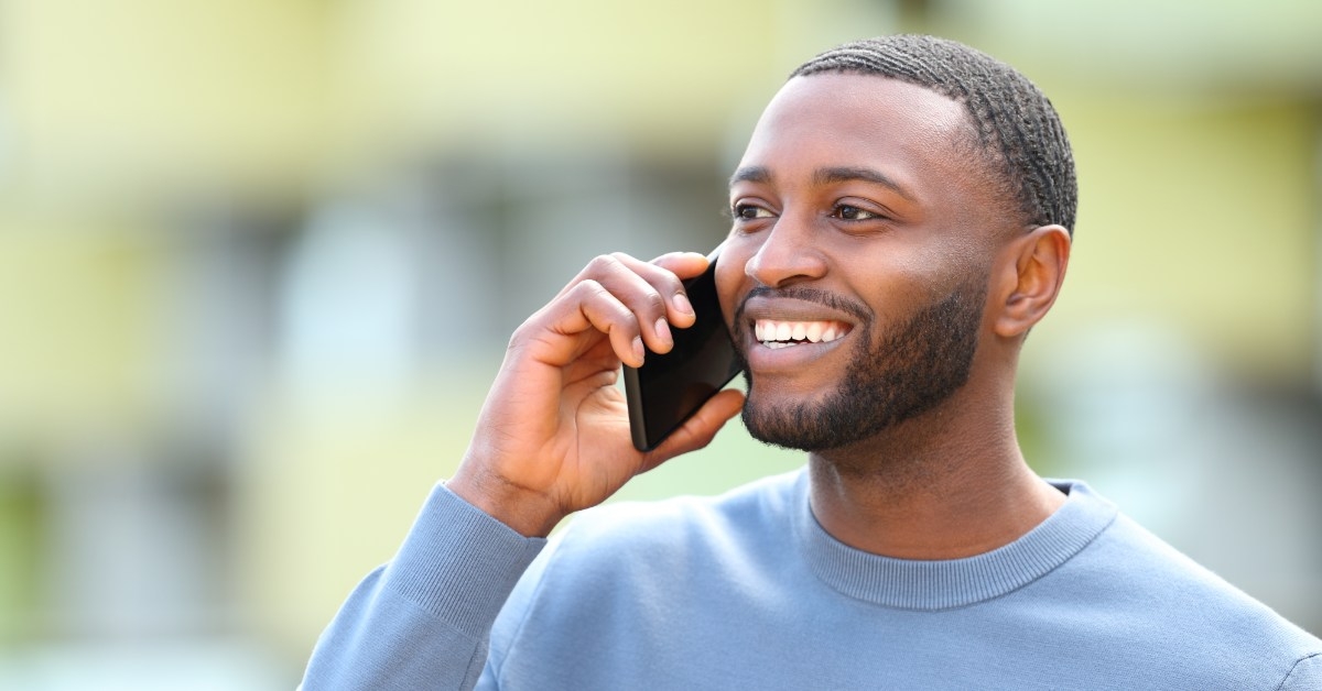 happy african man talking on call outdoor
