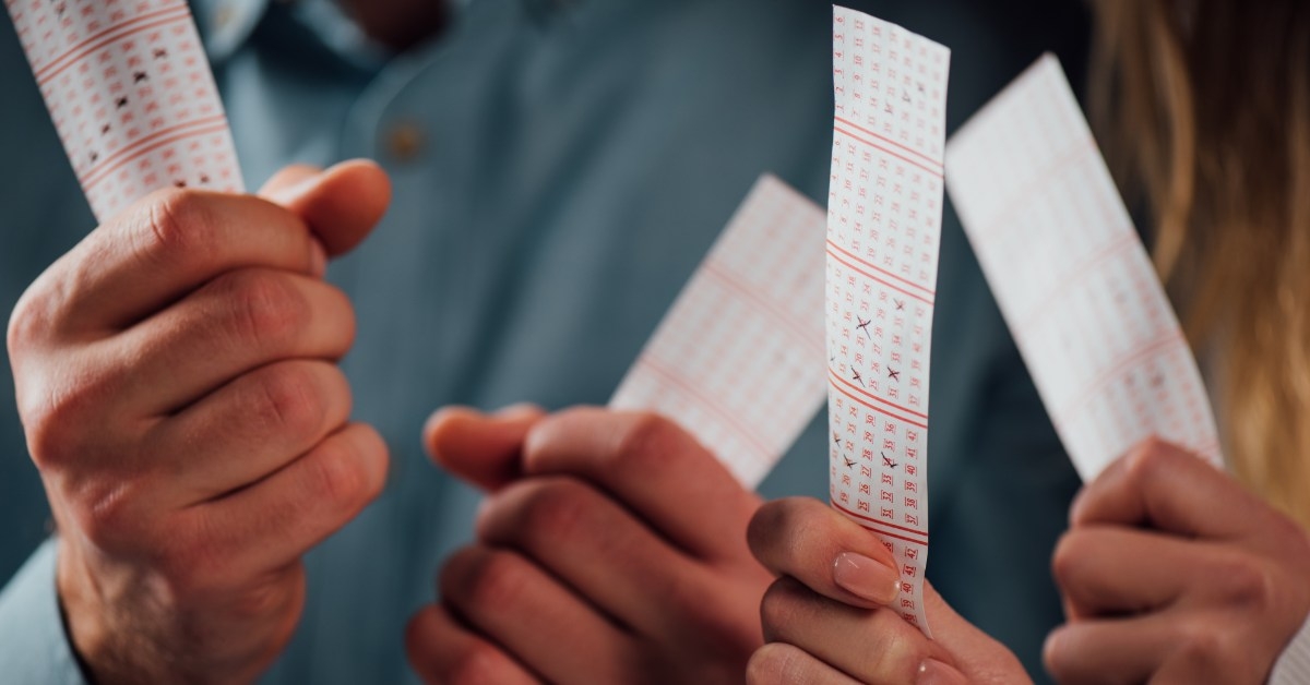 man and woman holding lottery tickets