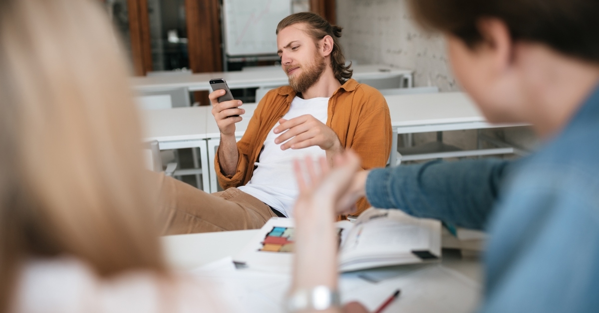 man with blond hair and beard sitting
