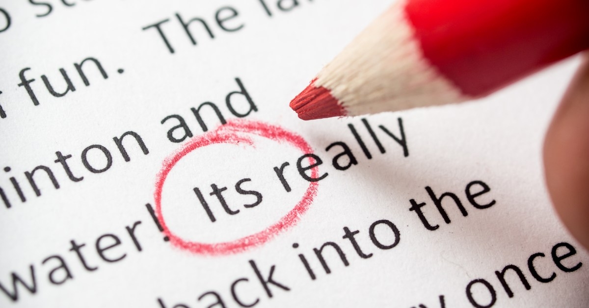 proofreading paper with red pencil