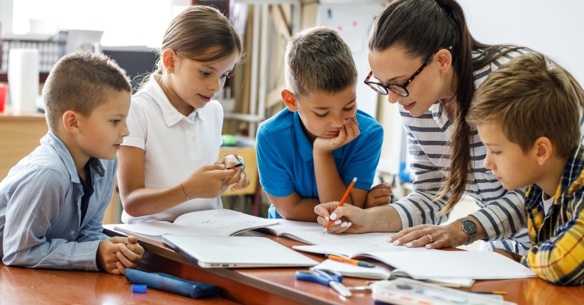 teacher teaching to students in classroom 