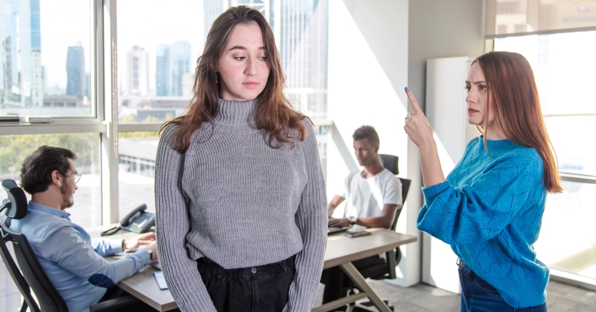 unhappy woman is exposed to discrimination and harrassment in a modern office