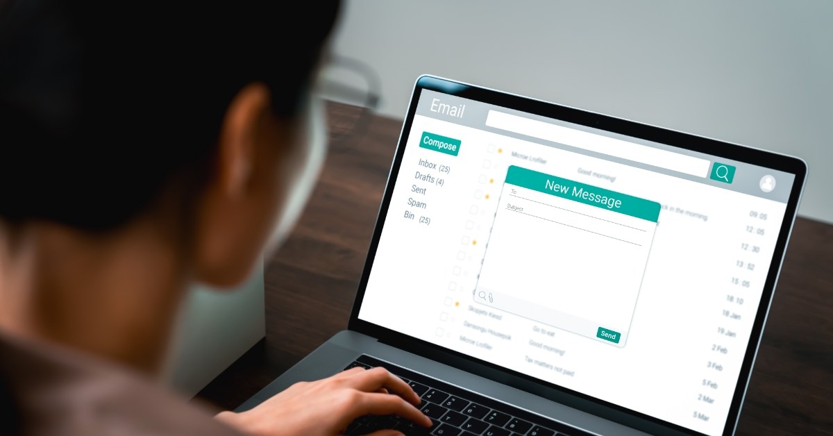 young woman on laptop composing email