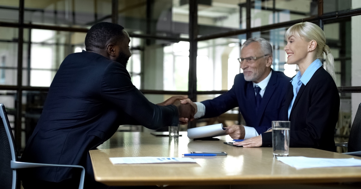 male applicant and company boss shaking hands