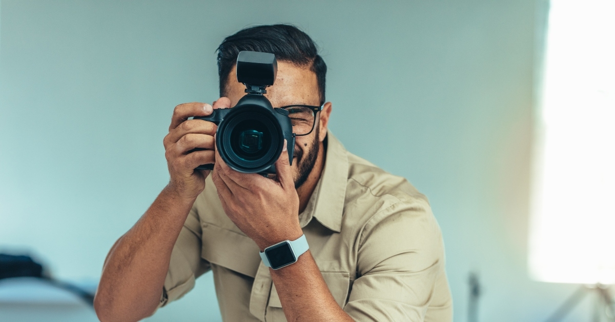 photographer taking photo standing in a studio
