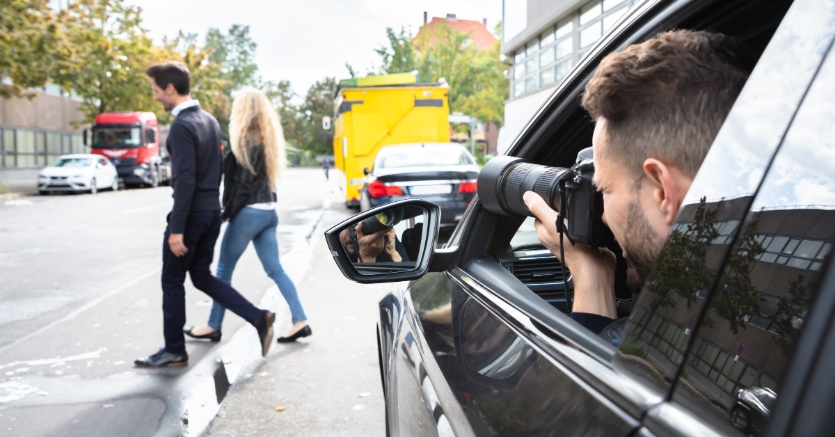private detective taking photos of man and woman