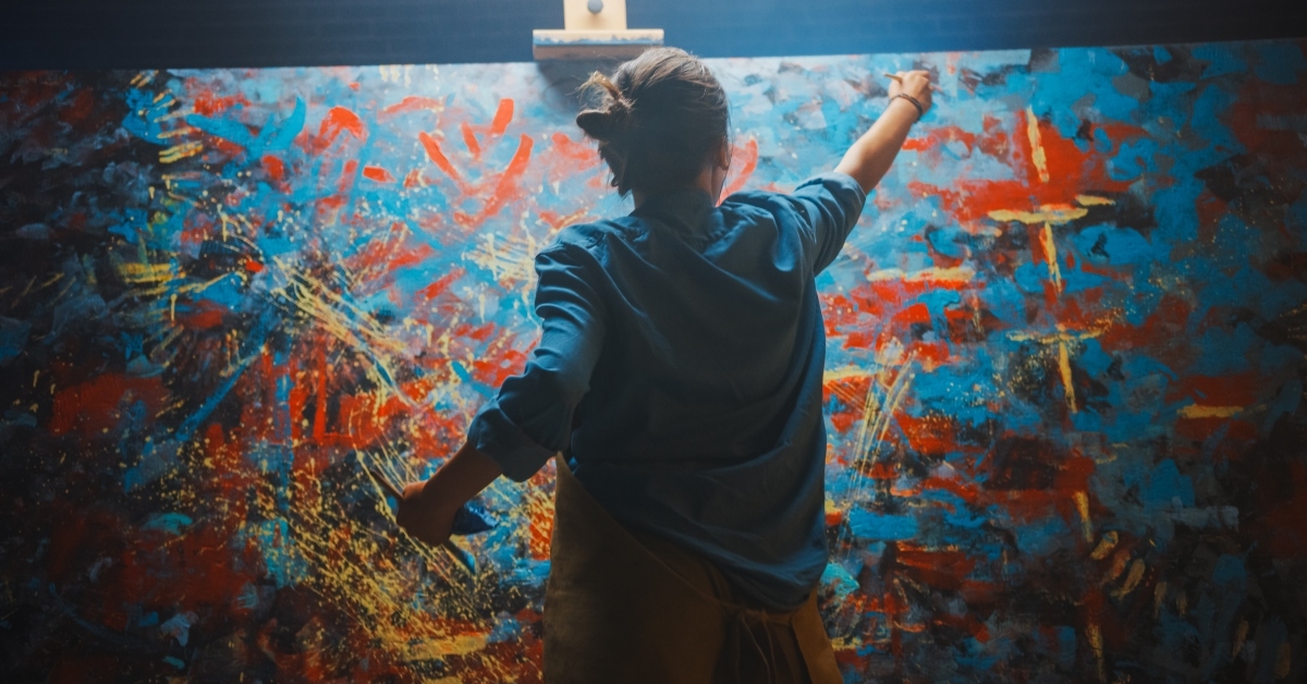 talented female artist works on abstract oil painting