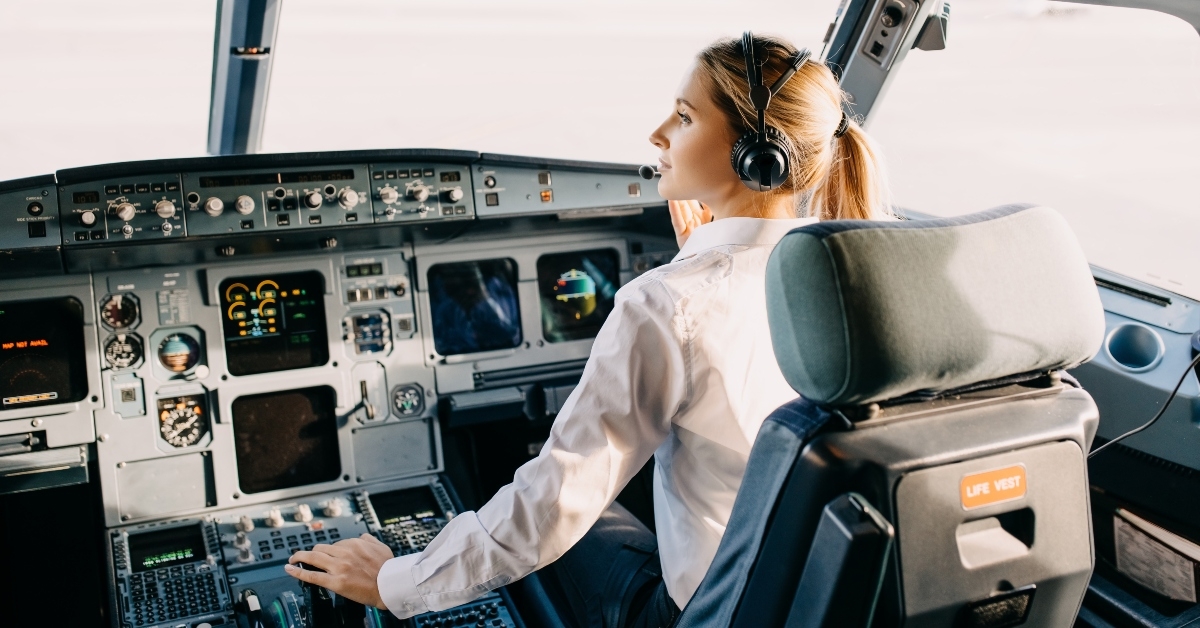 woman pilot sitting in airplane cockpit