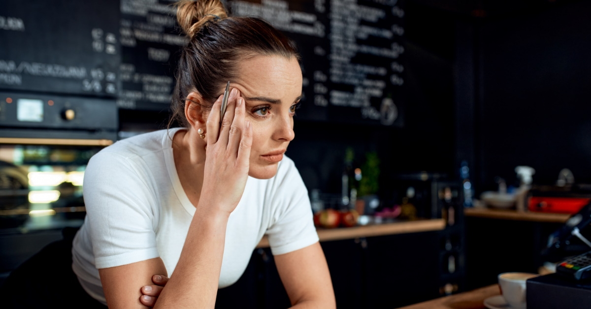 stressful young woman in cafe 