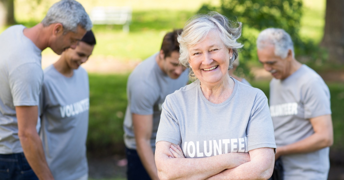 smiling senior lady in a volunteer shirt 