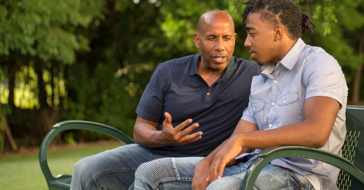 man giving advice to a teenager 
