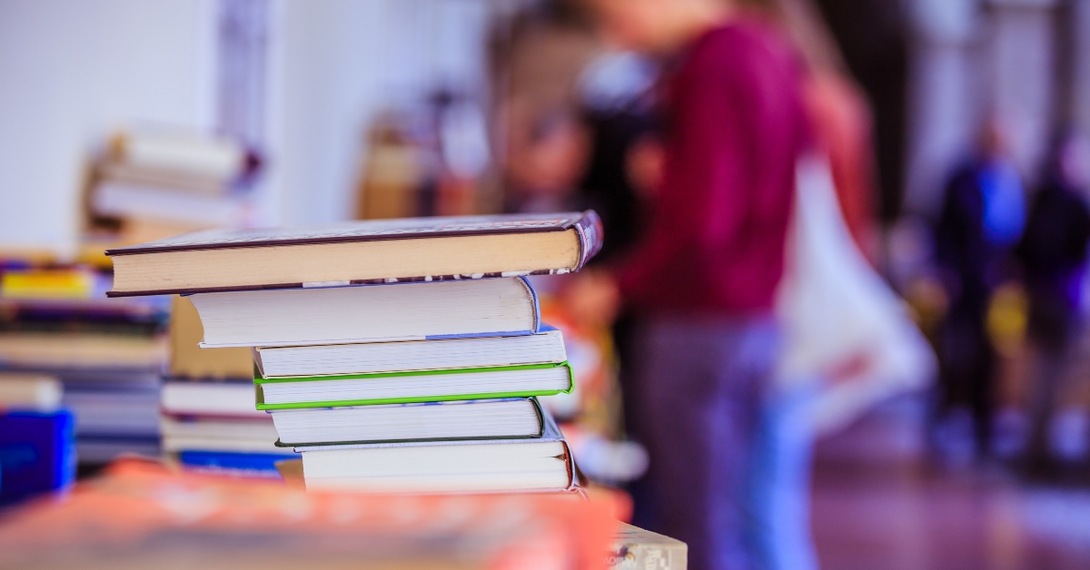stack of books at a charity book flea market