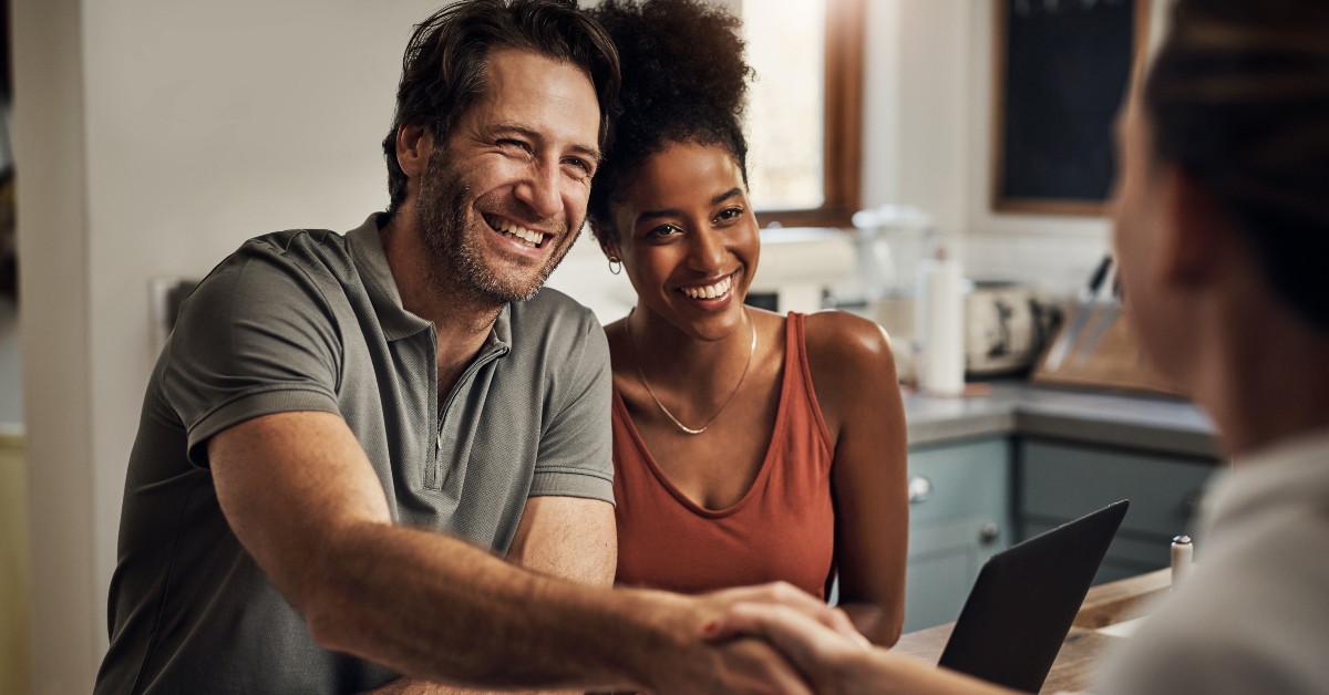 middle aged man shaking hands with a financial advisor