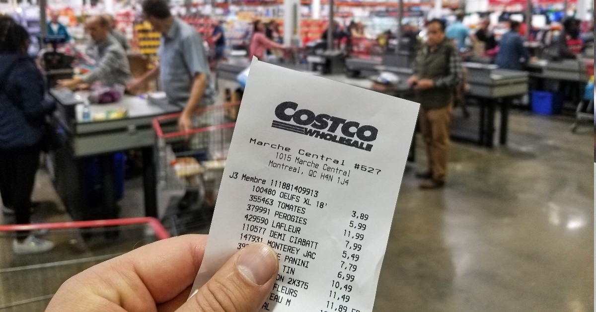 holding costco wholesale receipt at costco store