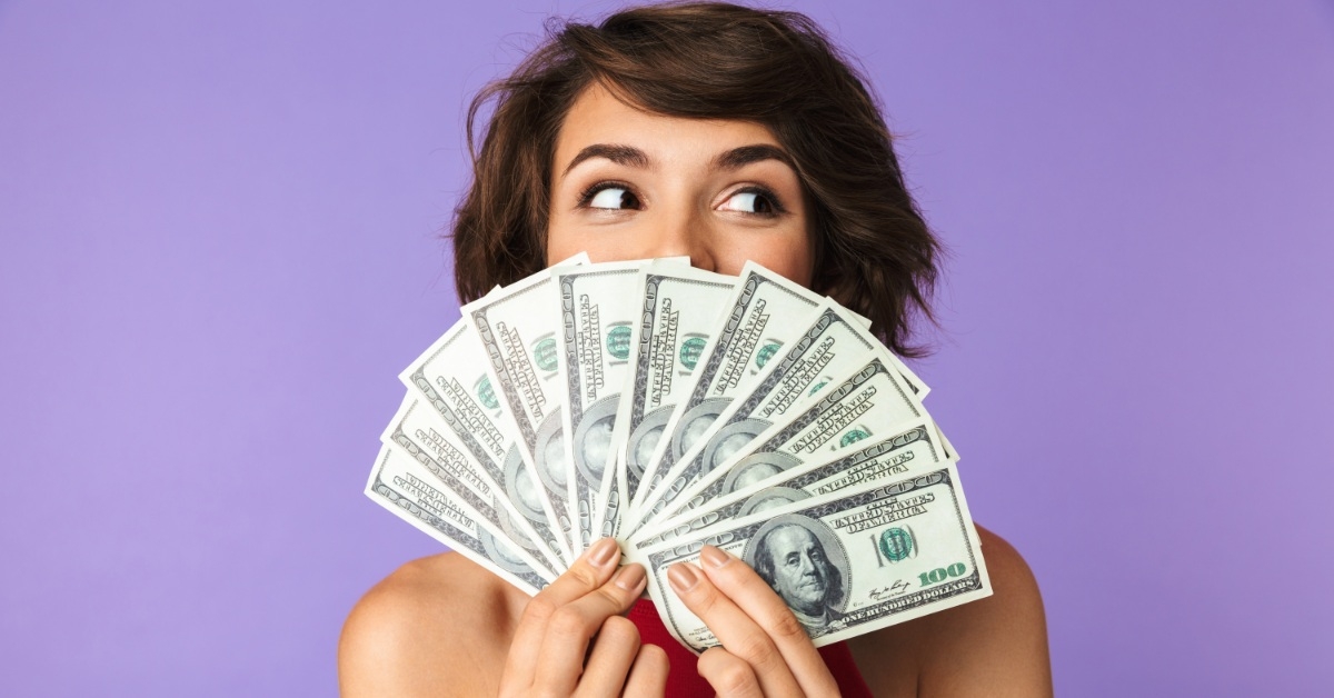 happy woman hiding face with money