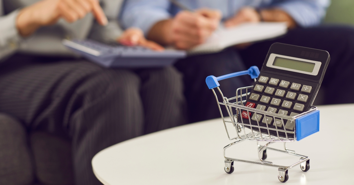 calculator and shopping cart on table 