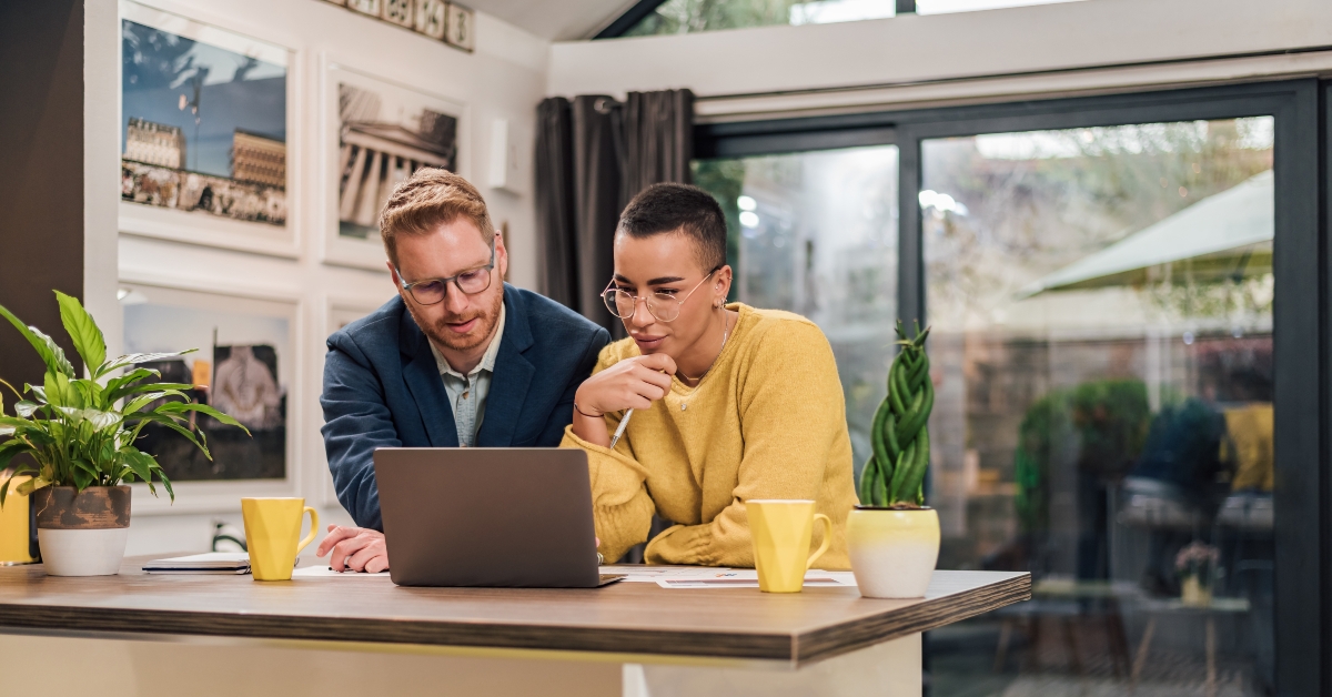 couple discussing new home project using laptop