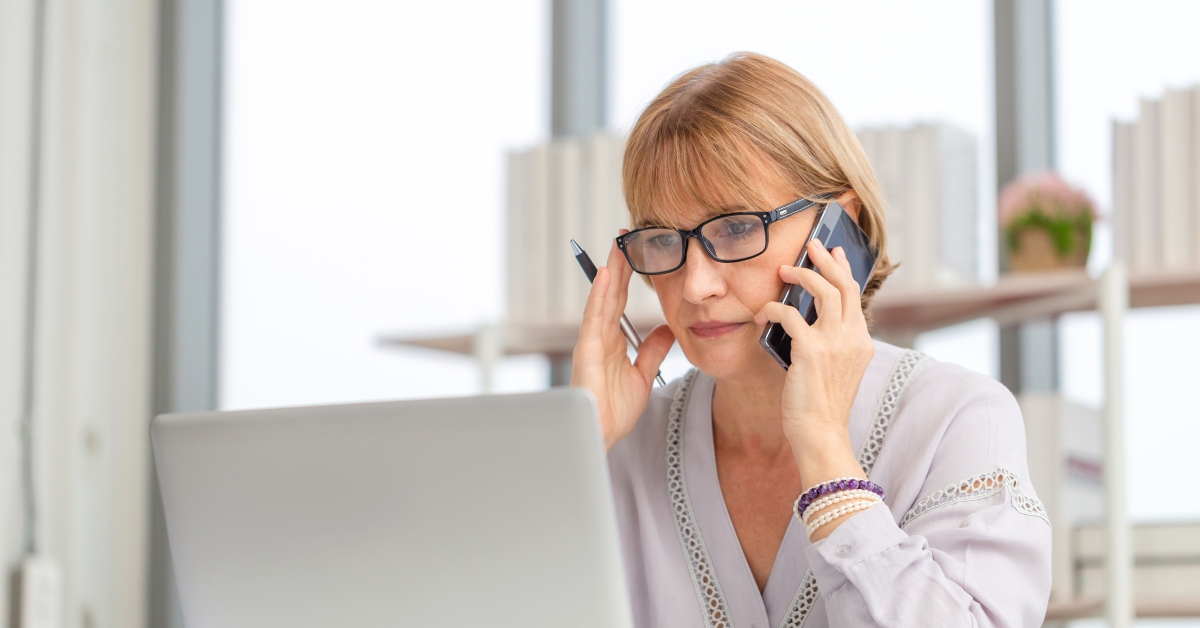 woman using laptop and smartphone at home