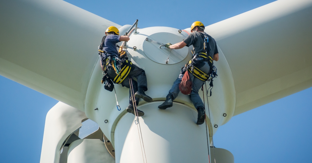 inspection engineers preparing to rappel down a rotor blade of a wind turbine