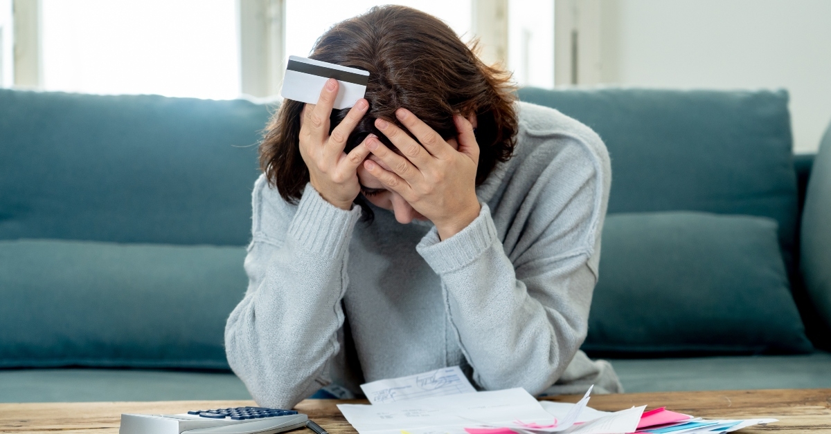 woman stressed with credit cards