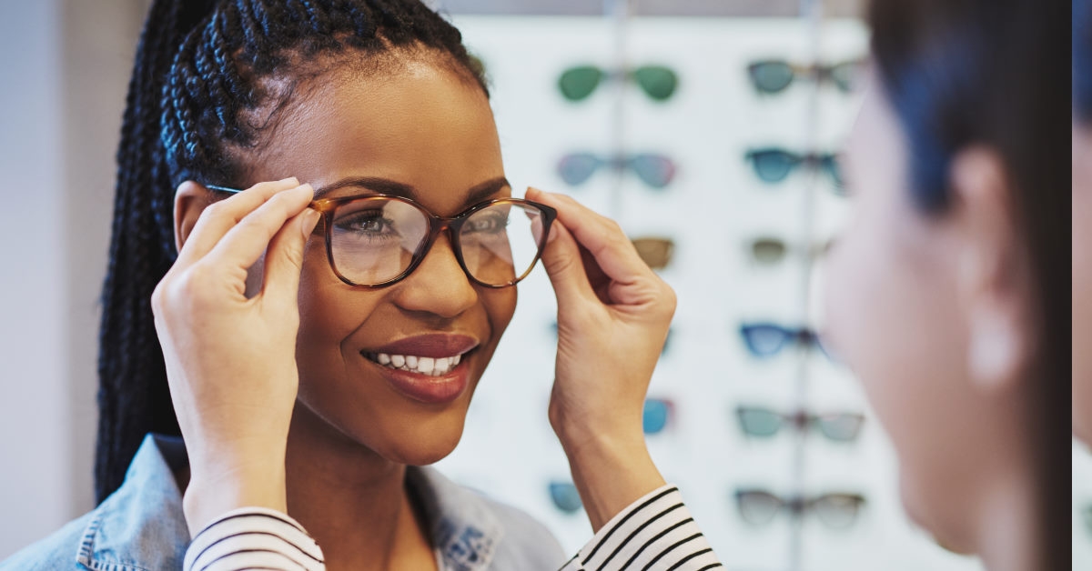 young african american woman trying out a pair of glasses .