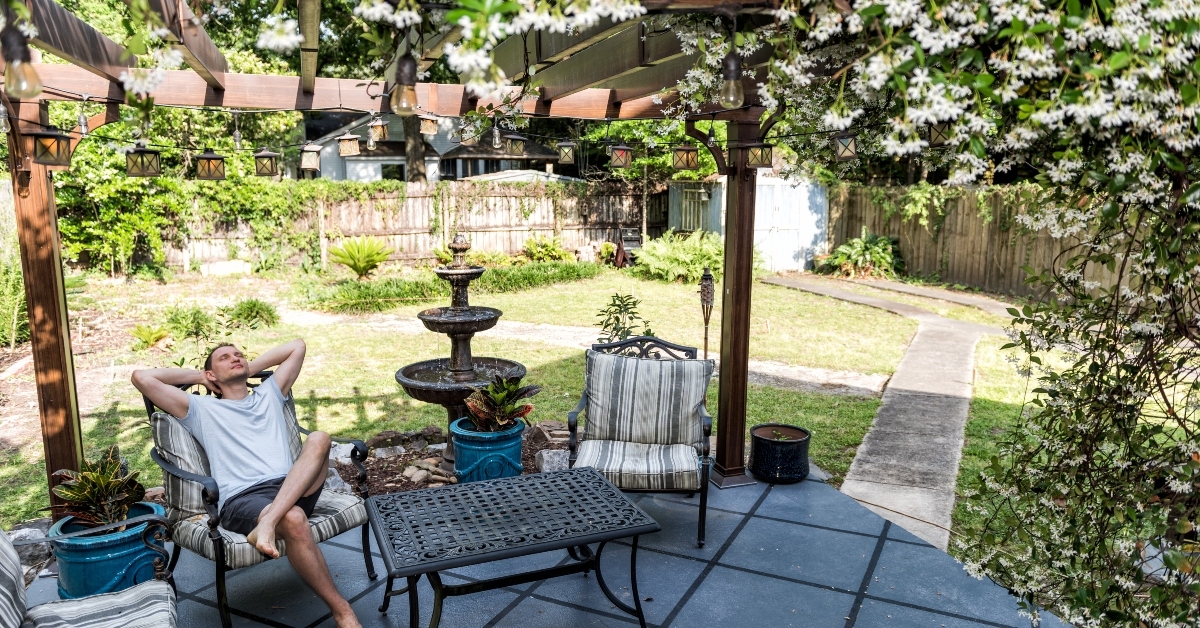man lying down on patio lounge chair in outdoor