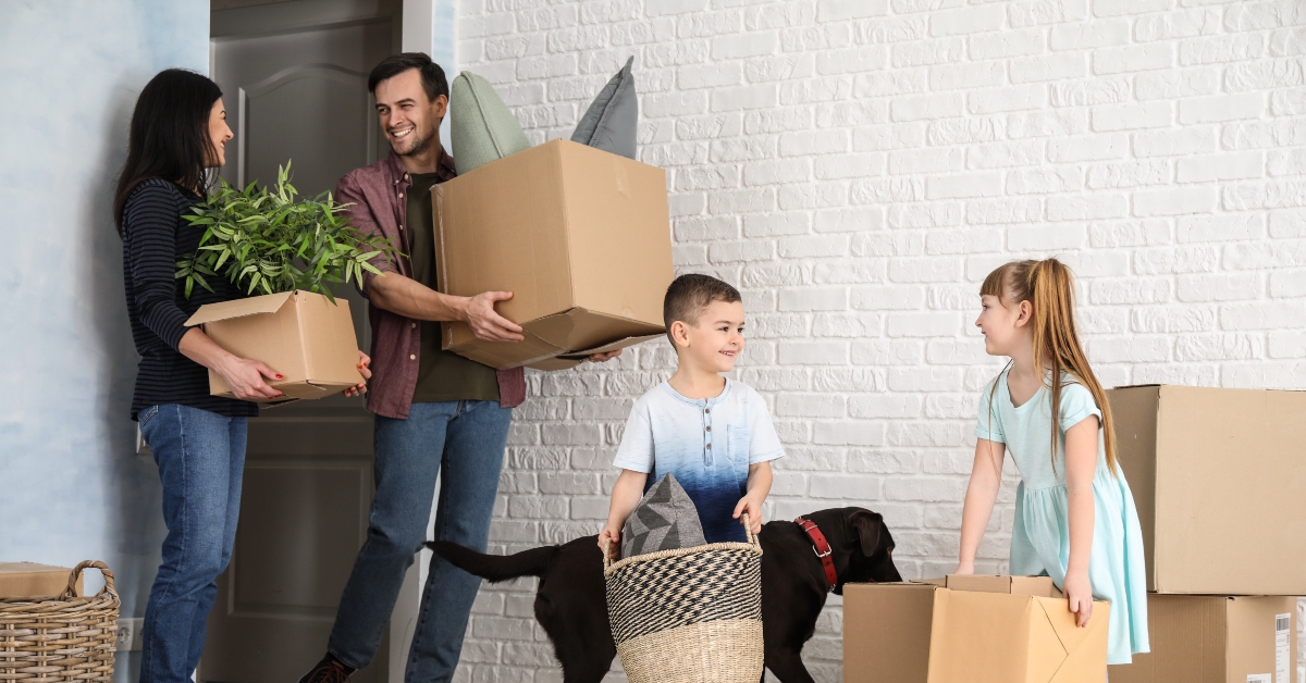 family with cardboard boxes after moving into new house