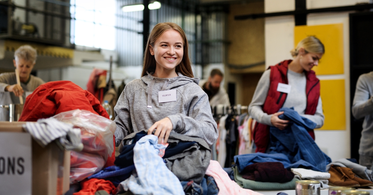 volunteers sorting out donated clothes in community charity donation center