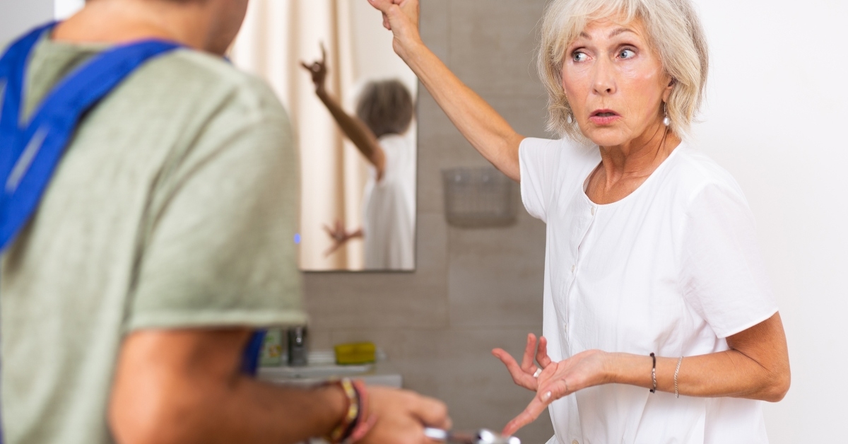 elderly woman talking with plumber