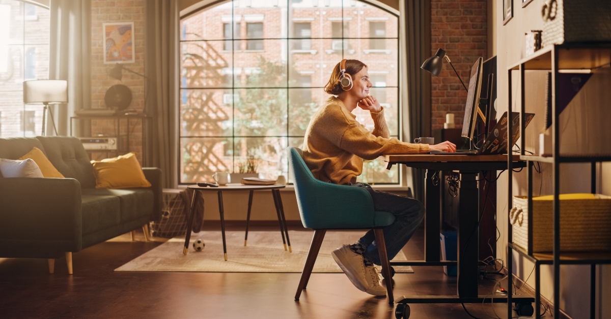 man working from home on desktop computer
