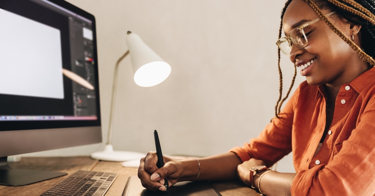 happy african american girl drawing graphics on tablet 