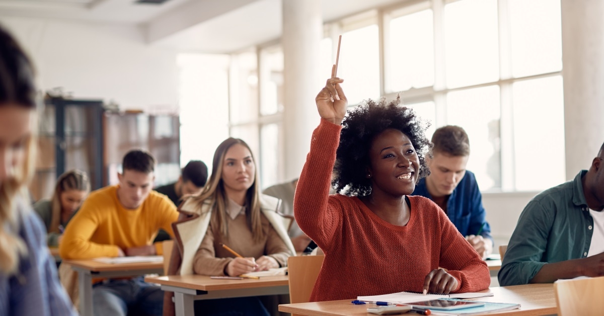 happy african american woman raising hand in class 