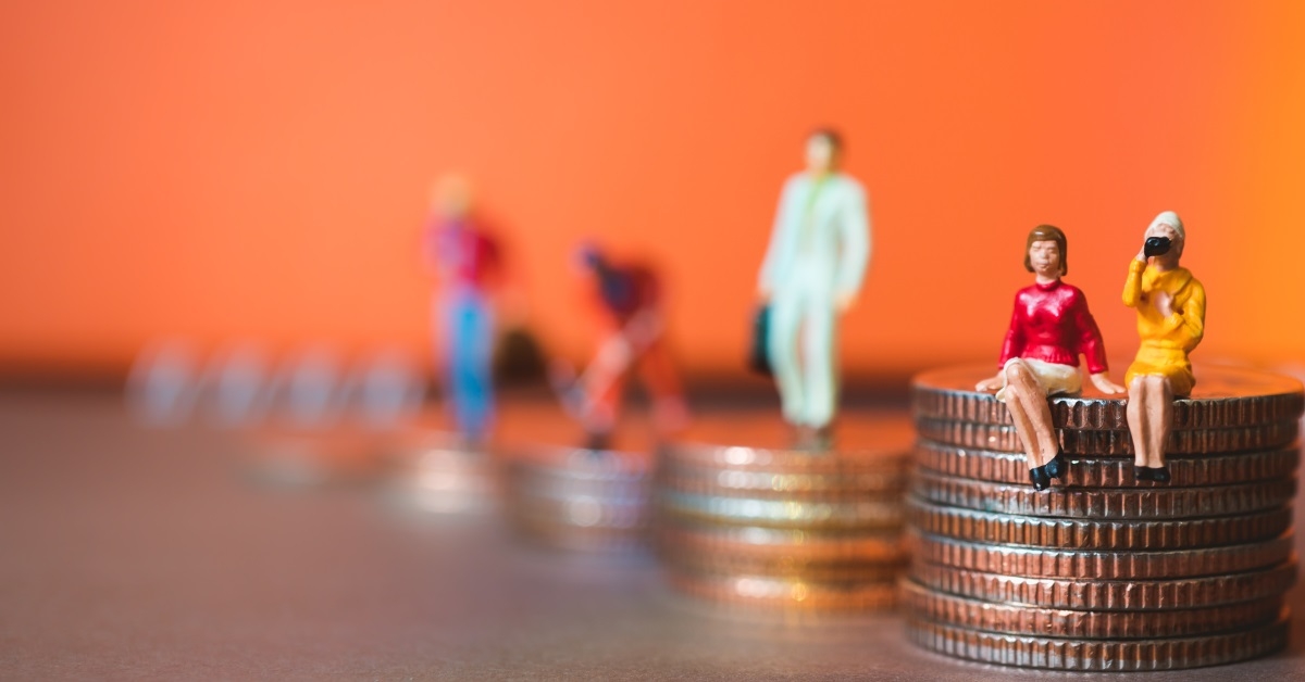 miniature sculptures of people on top of pile of pennies