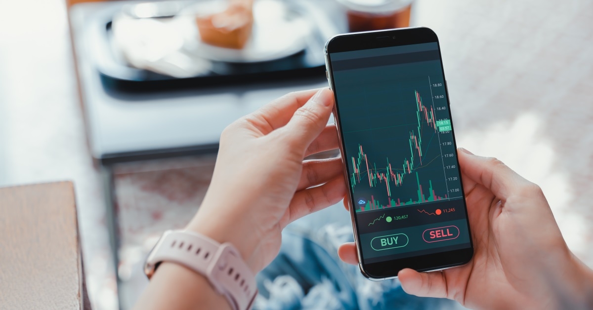 woman checking stocks on smartphone