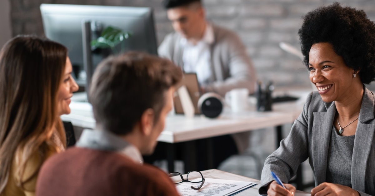 african american advisor giving advice to young couple