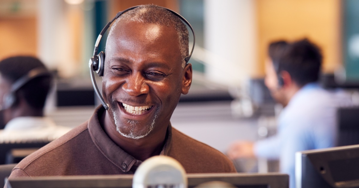 mature african american man working in call center laughing