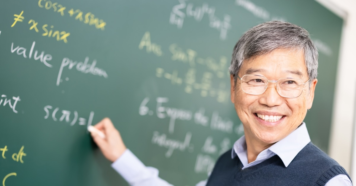 happy senior asian professor teaching calculus in classroom