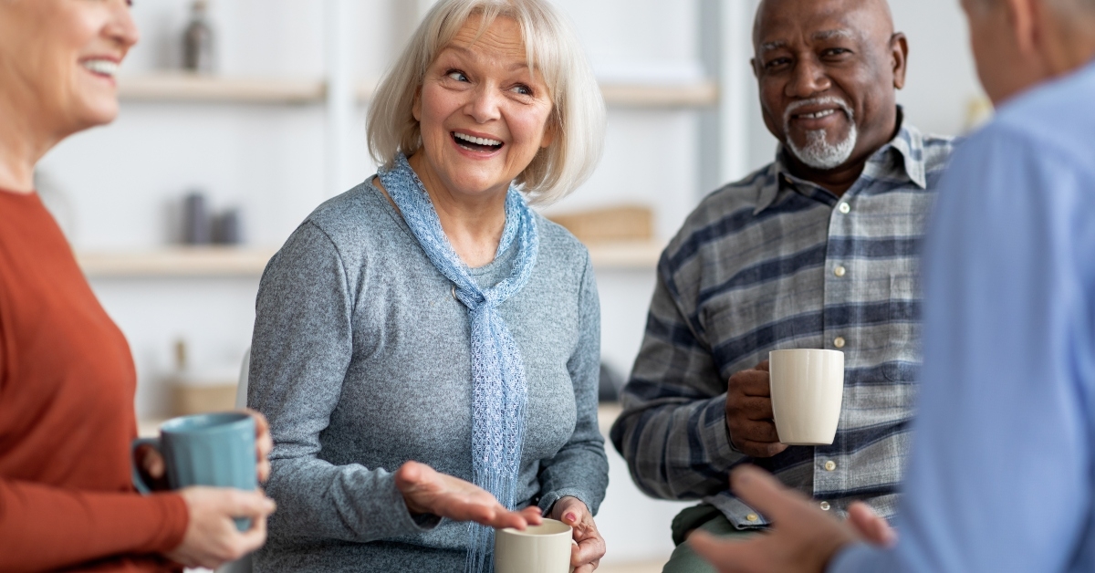 elderly people drinking tea while chatting