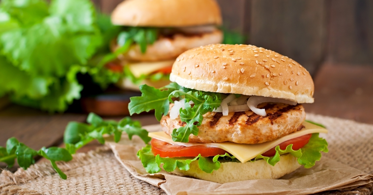 Two turkey burgers with a lot of green lettuce